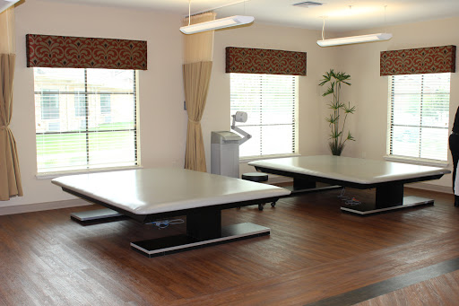 A spacious room featuring modern tables and ample natural light.