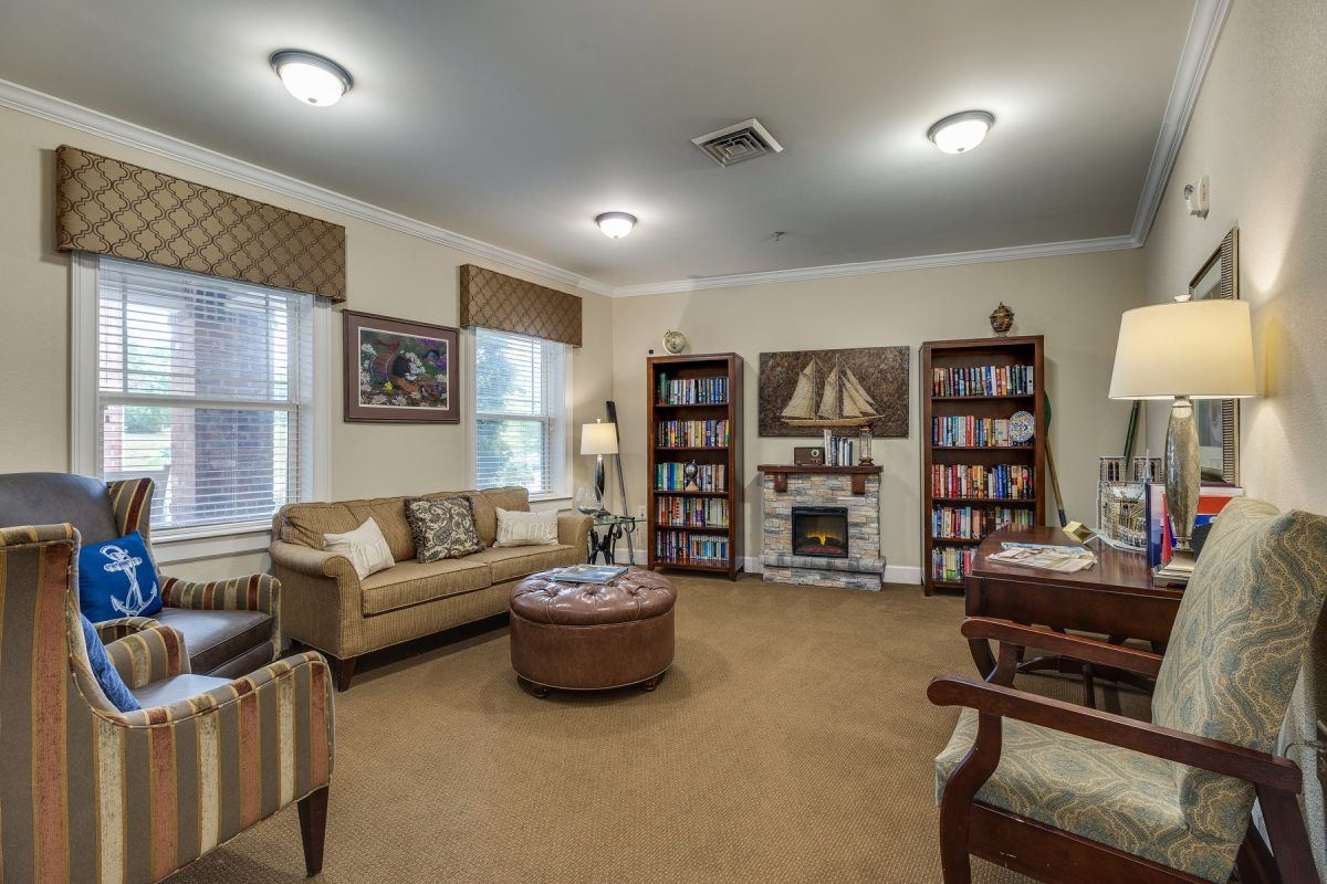 A cozy living room with bookshelves and comfortable seating.