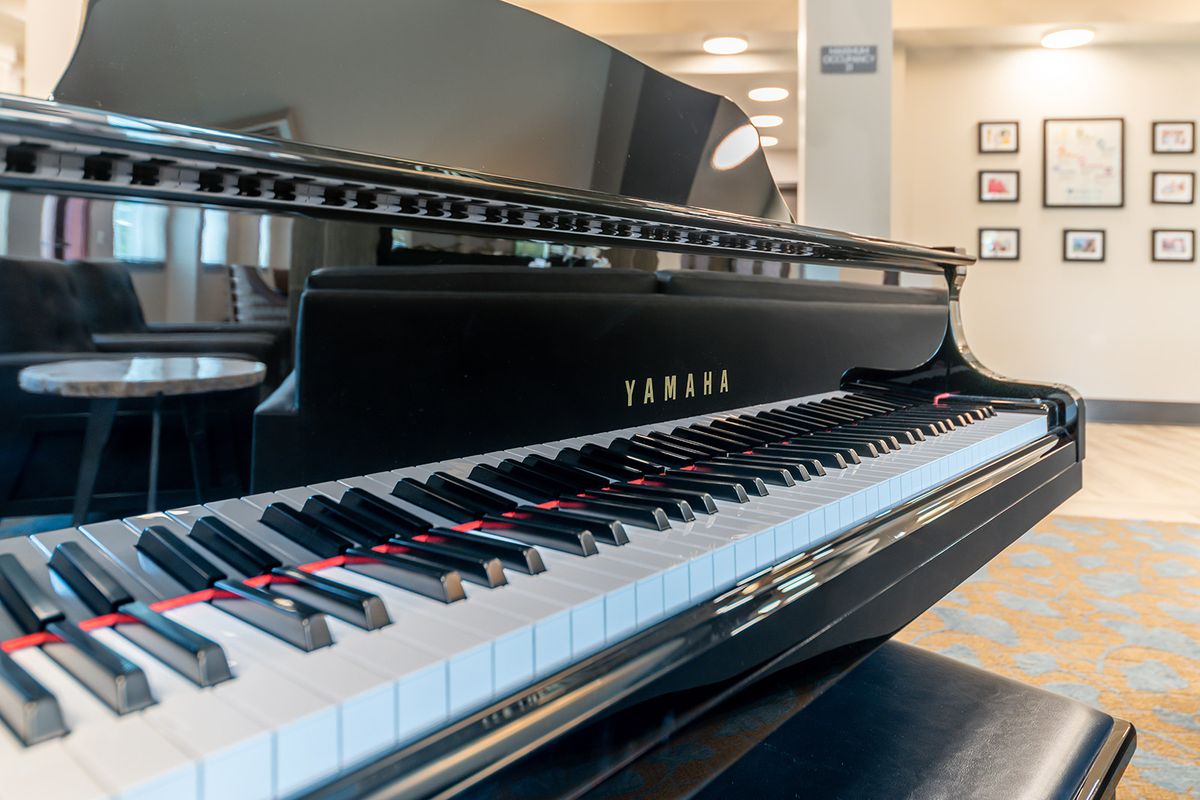 A Yamaha grand piano with an elegant design, showcasing its black and white keys.