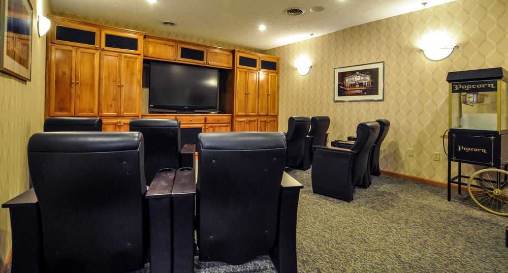 A cozy home theater setup with comfortable seating and a large screen for entertainment.