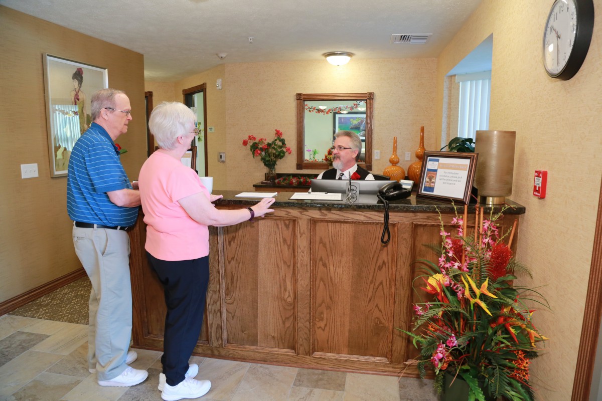 Two guests checking in at a hotel reception.