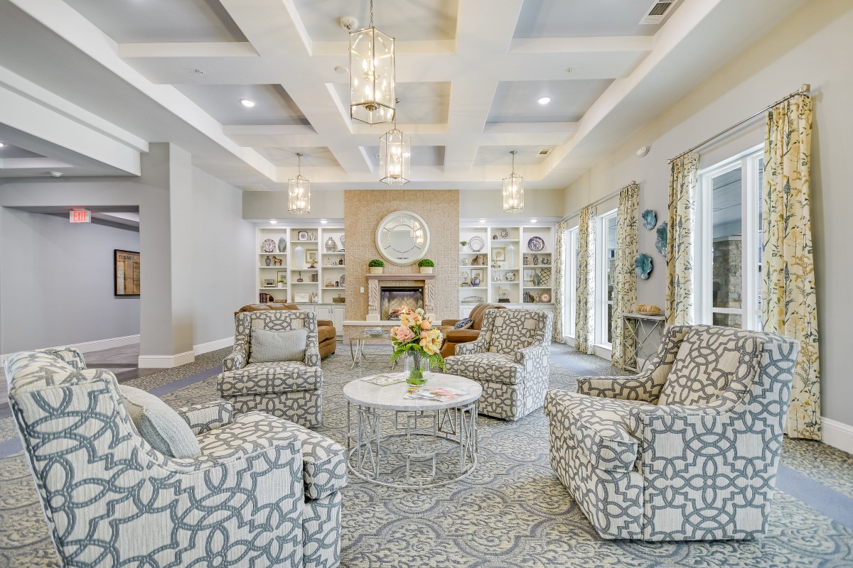 A stylish living room with patterned armchairs and a cozy fireplace.