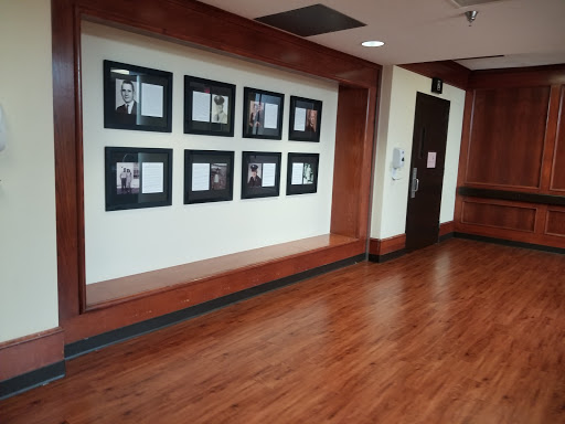 A hallway featuring a gallery of framed photographs on the wall.