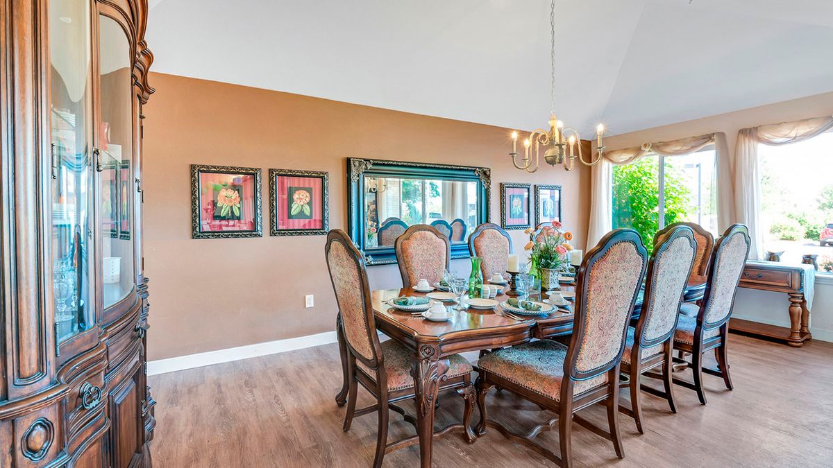 A cozy dining room with elegant furniture and decor.