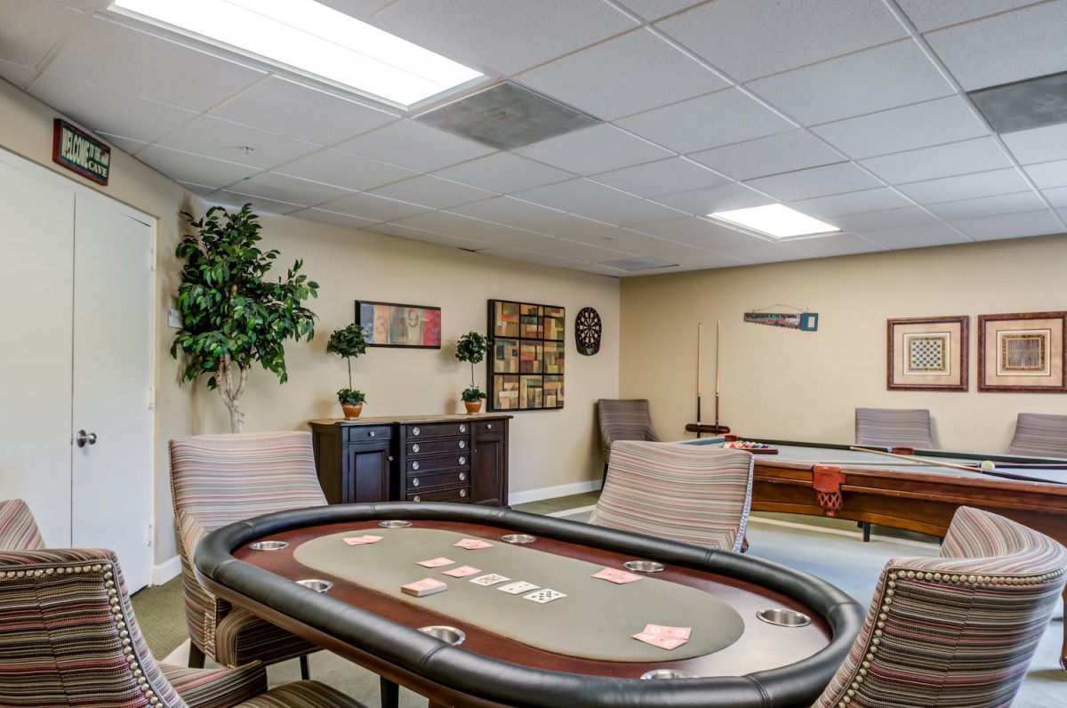 A cozy game room featuring a poker table and various decorations.