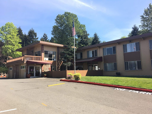 A well-maintained hotel with a welcoming exterior and a lush green space.