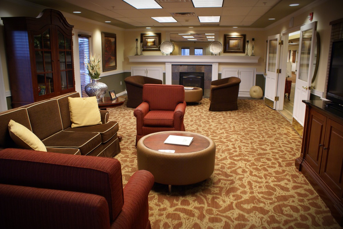 A cozy lobby area featuring comfortable seating and a fireplace.