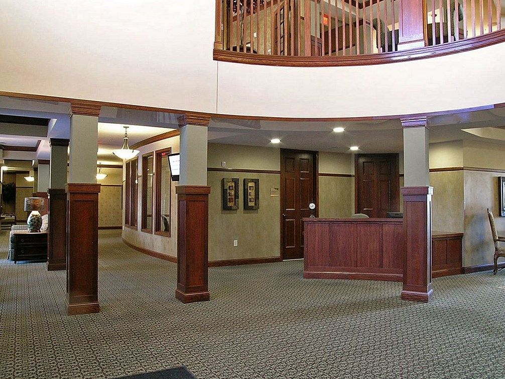 An indoor reception area with wooden accents and a carpeted floor.