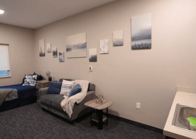A cozy living room with a sofa and minimalist wall art decor.