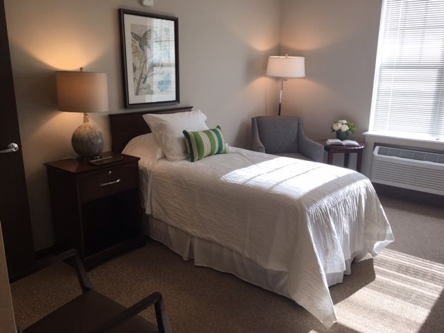 A cozy and minimalist bedroom with a single bed and modern decor.