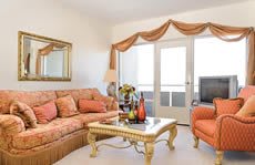 A traditional style living room with a cozy sofa and elegant coffee table.