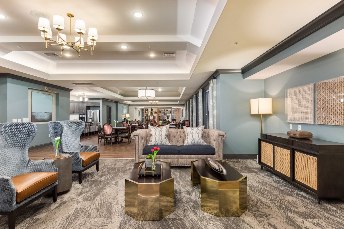 A modern and elegantly designed living room with stylish furniture and lighting.