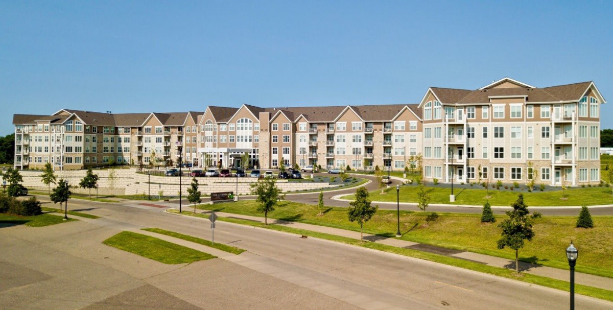 A modern suburban apartment complex with landscaped surroundings.