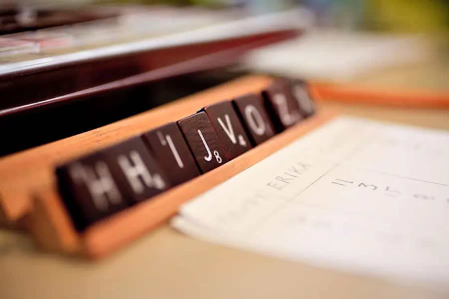 Close-up of Scrabble tiles arranged on a rack.