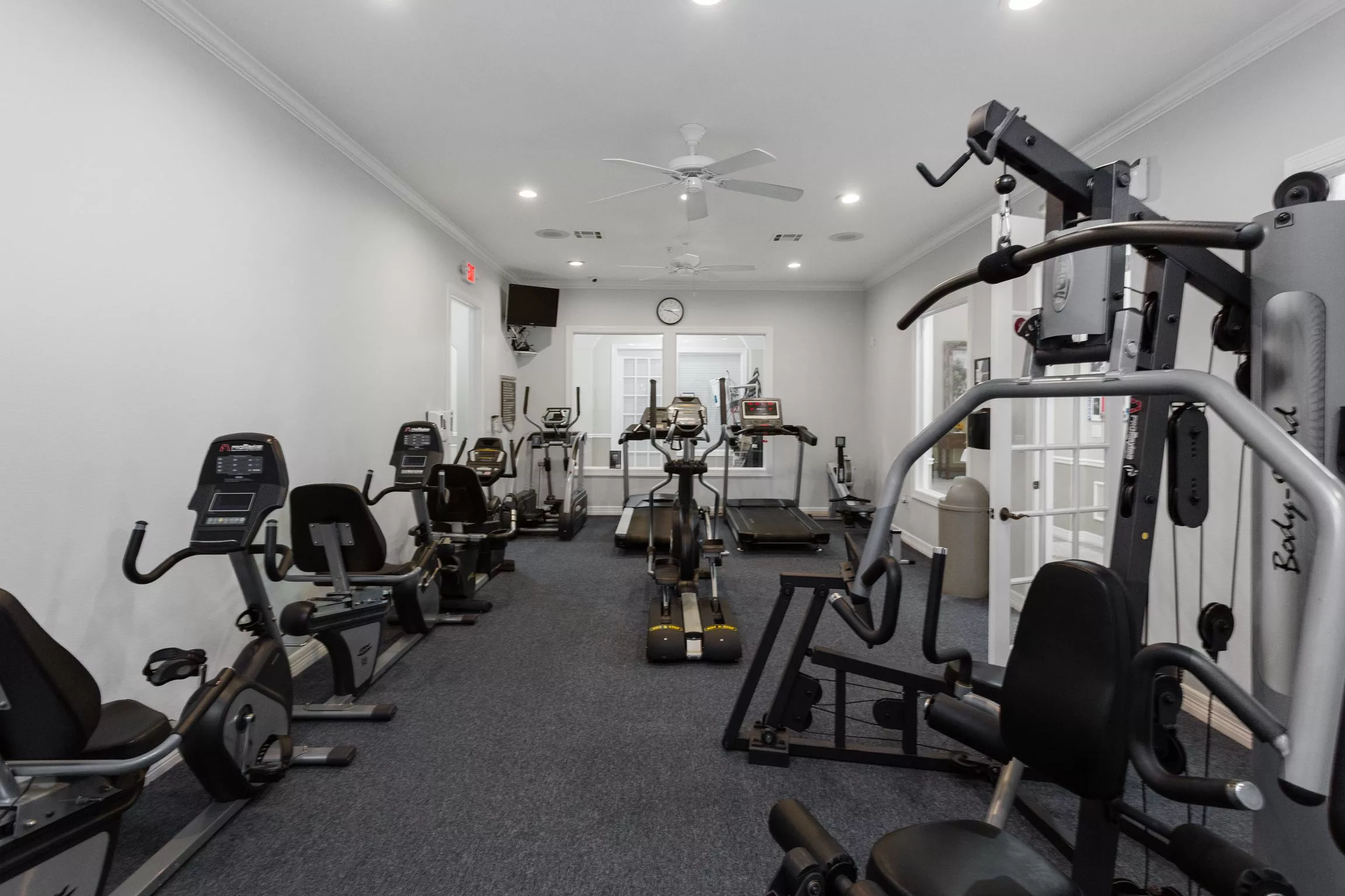 A well-equipped gym featuring a variety of exercise machines and equipment.