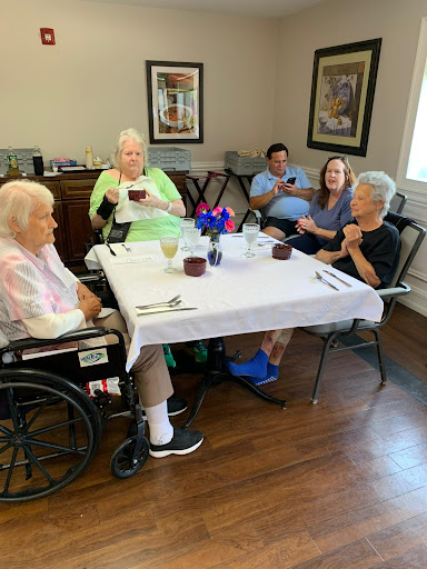 Seniors enjoying a meal together in a care facility.
