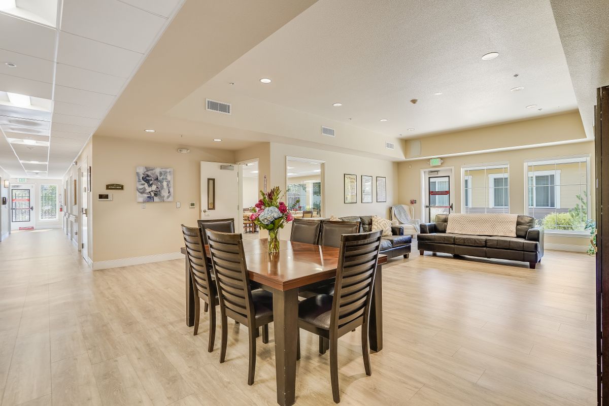 A modern open-plan dining and living area with elegant furnishings and decor.
