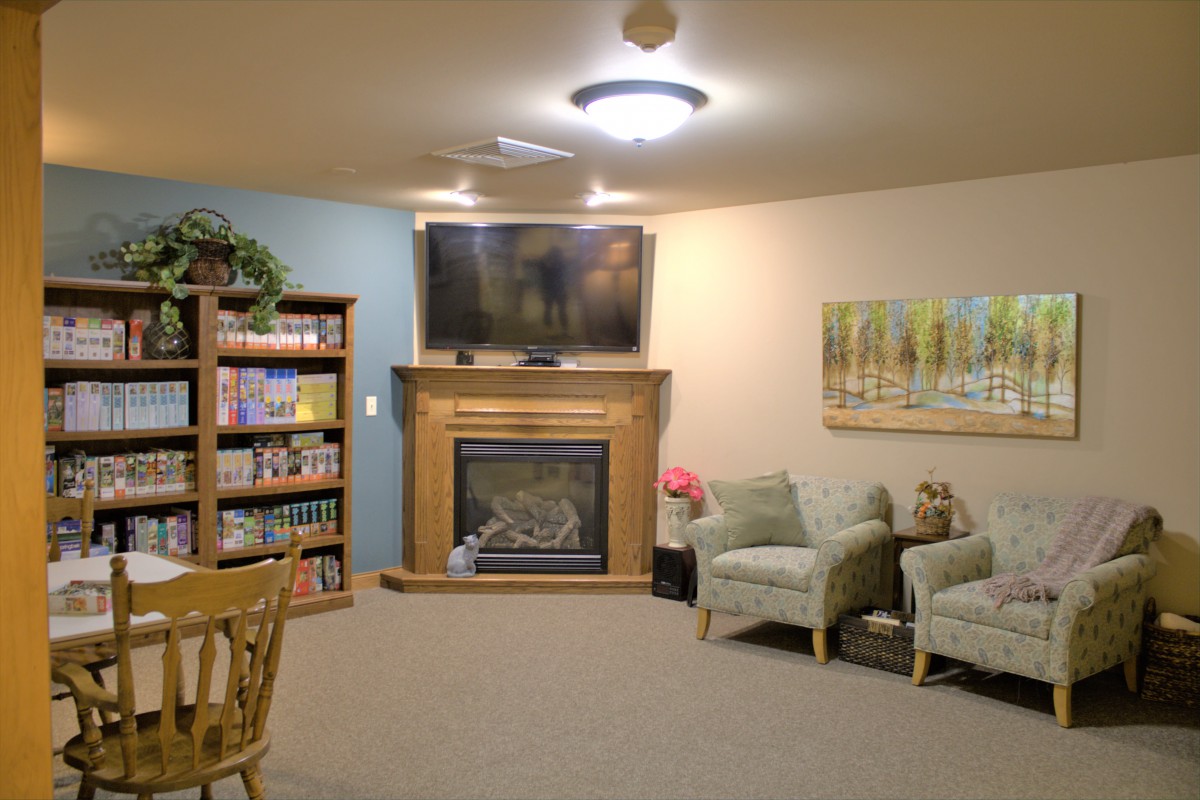 A cozy living room with a fireplace, TV, and comfortable seating.