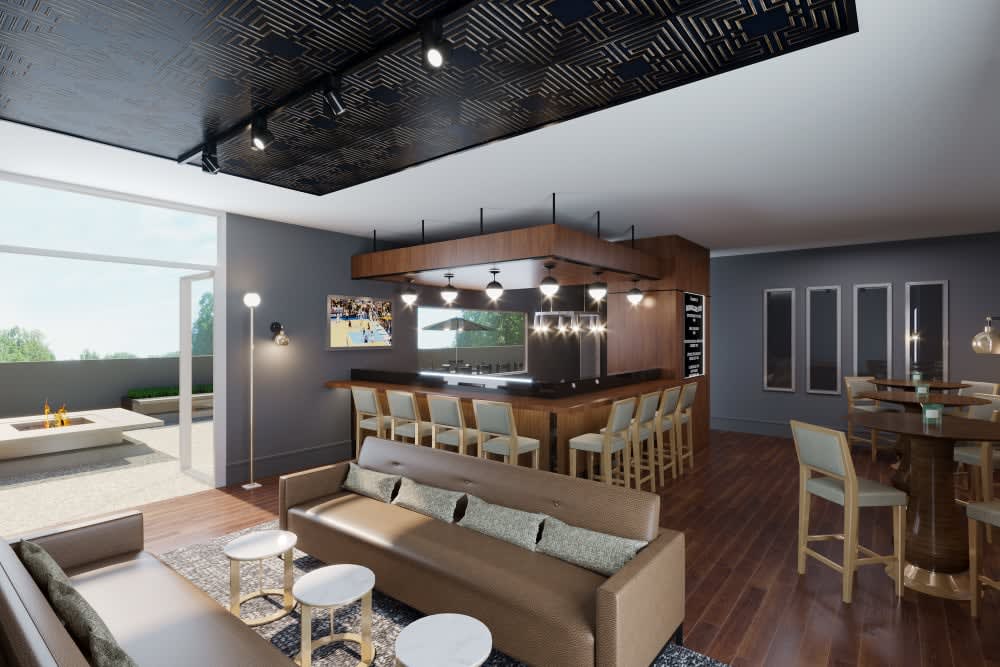 A modern open living space featuring a stylish bar area with wooden accents and comfortable seating.
