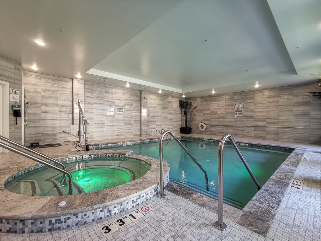 A luxurious indoor pool and jacuzzi area designed for relaxation and wellness.