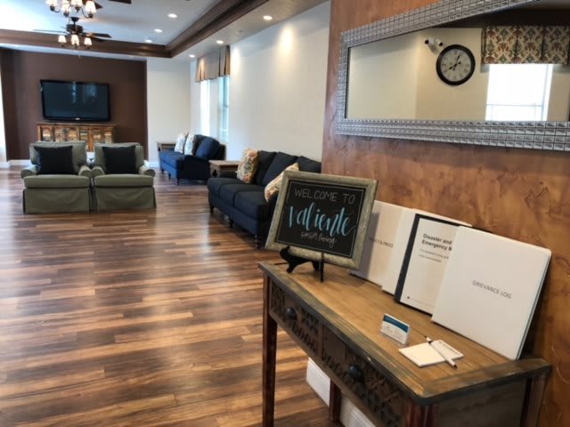 A well-appointed waiting area featuring comfortable seating, a large mirror, and elegant decor.