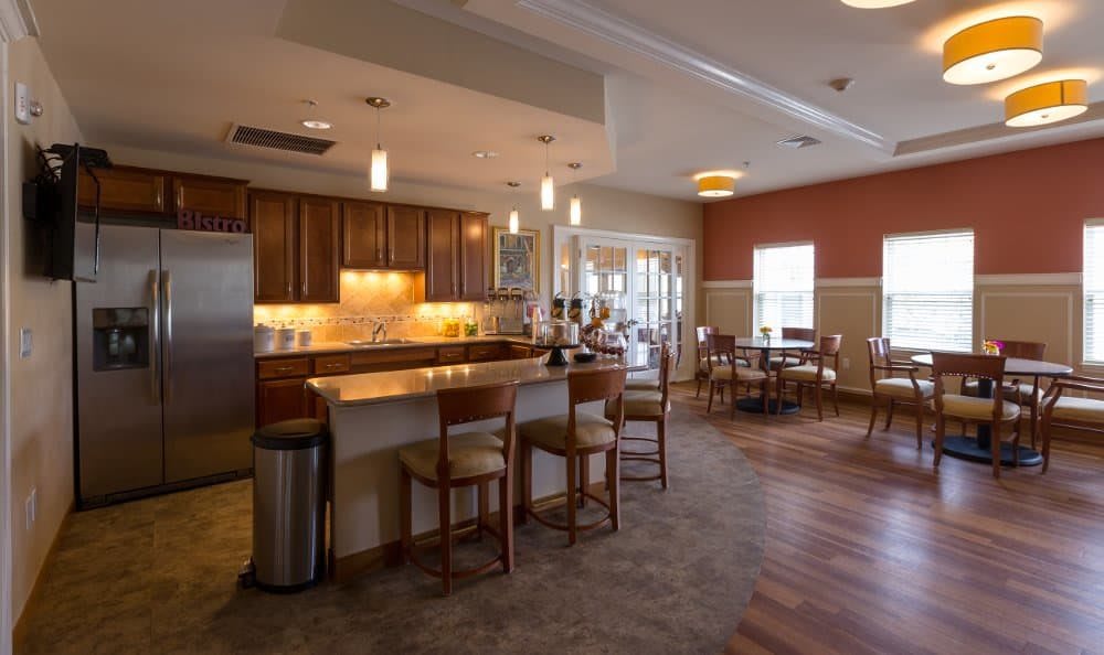 A modern kitchen and dining area with wooden furniture and soft lighting.