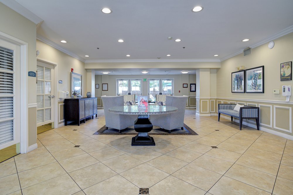 A spacious and well-lit lobby area with modern seating and tiled flooring.