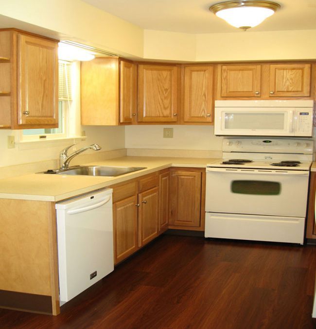 A kitchen with wooden cabinets and modern appliances.