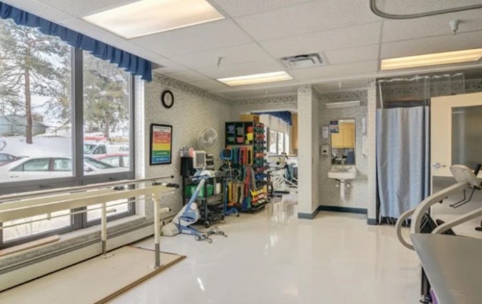 A well-equipped rehabilitation room with medical devices and a clean, organized setup.