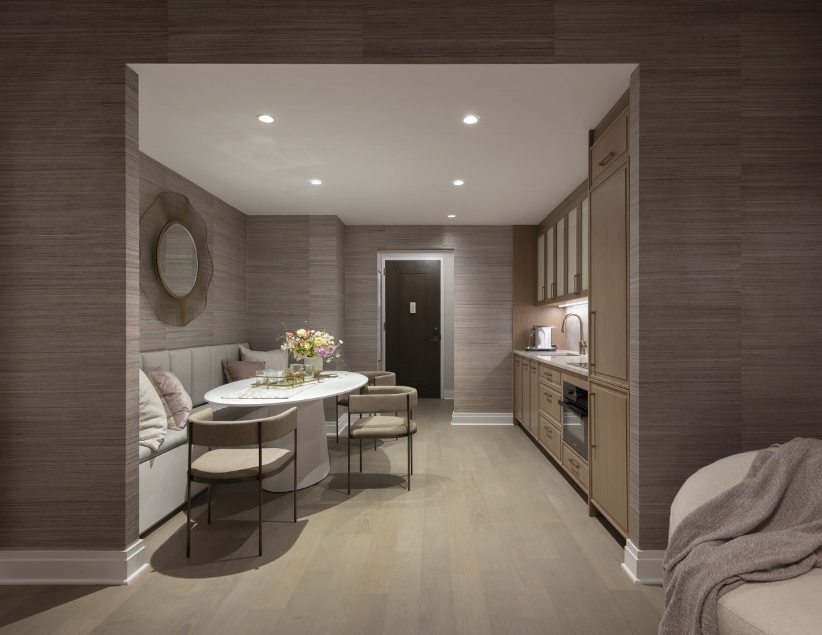 A modern kitchen and dining area featuring contemporary furniture and minimalist decor.