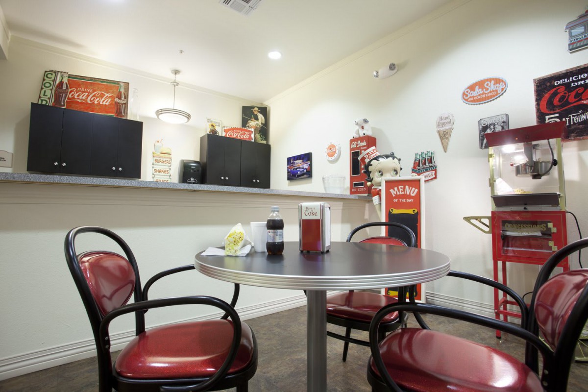 A retro-themed diner interior with vintage decor and red seating.
