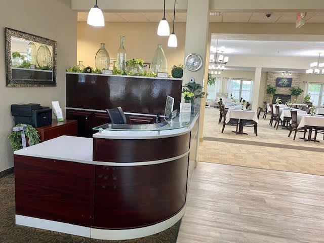 A modern reception desk in a formal office setting with decorative elements.