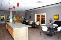 A modern dining area with a bar counter and stylish lighting.