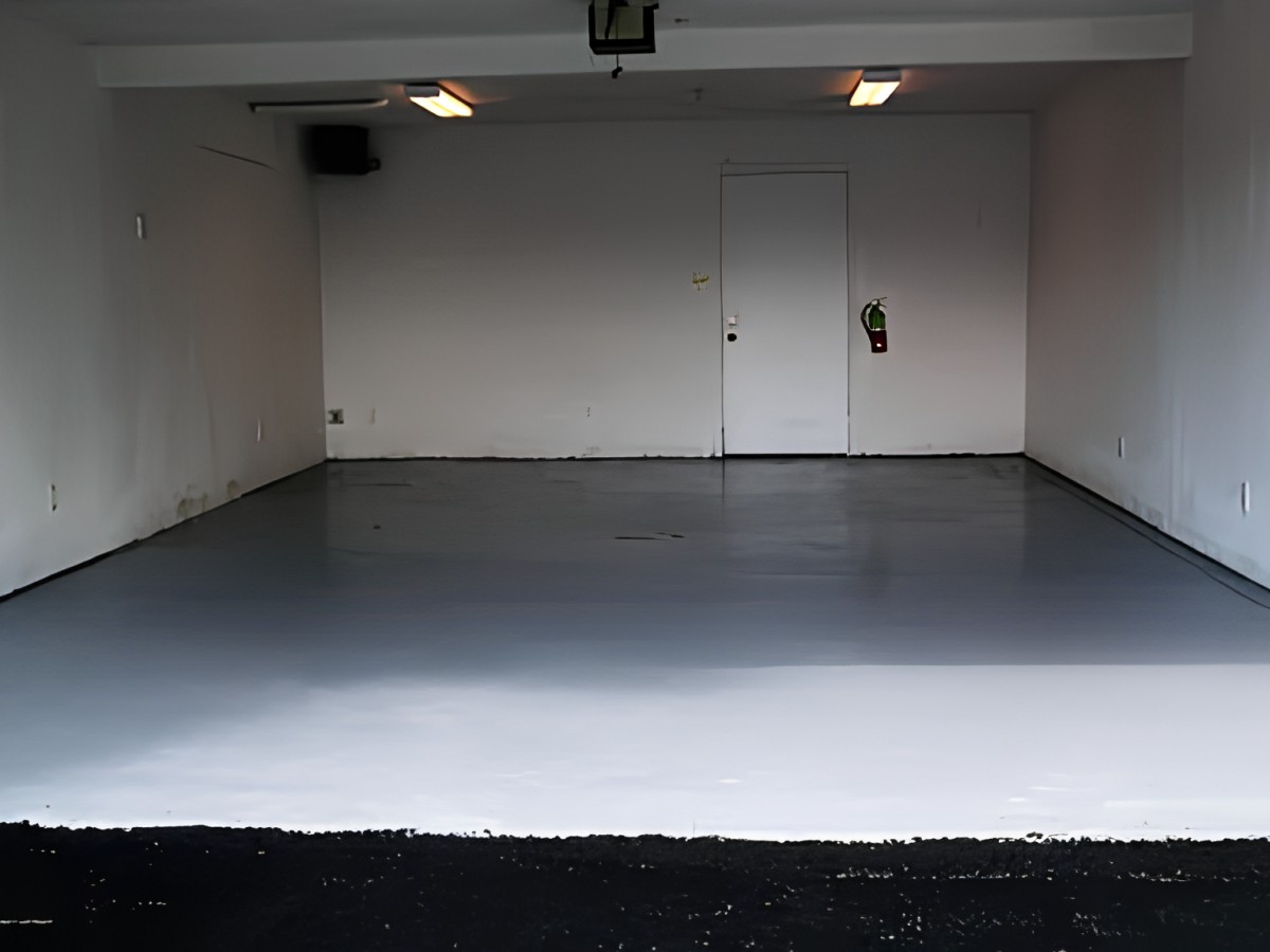 An empty, clean garage interior with overhead lighting.