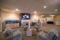 A cozy living room featuring a fireplace, television, and comfortable seating.