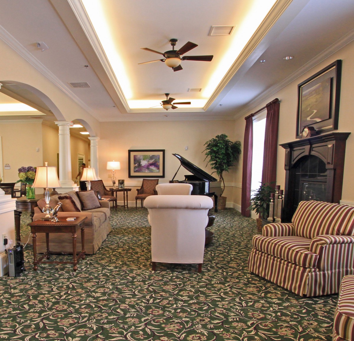 A cozy living room with elegant furniture and a grand piano.