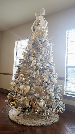 A beautifully decorated Christmas tree adorned with silver and gold ornaments, bringing festive cheer to the room.