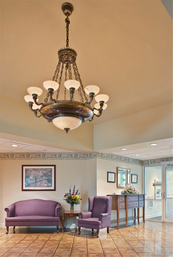 A beautifully designed chandelier illuminating a cozy living space.