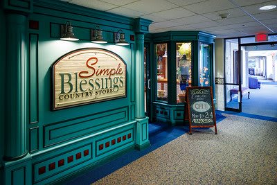 Entrance to Simple Blessings Country Store with vibrant teal decor and signage.