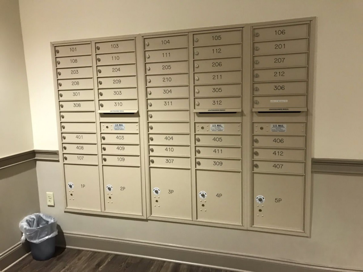 A set of wall-mounted mailboxes typically found in an apartment building.