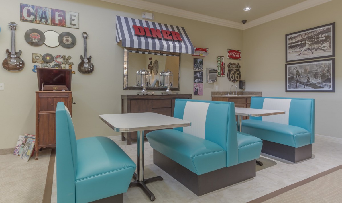A retro-style diner with blue booths and vintage decor.
