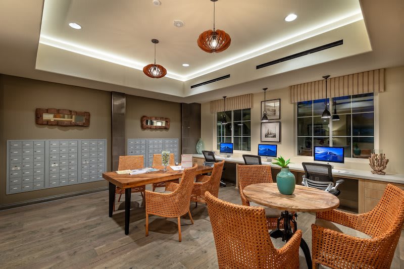 A modern office space with computers, stylish chairs, and ambient lighting.