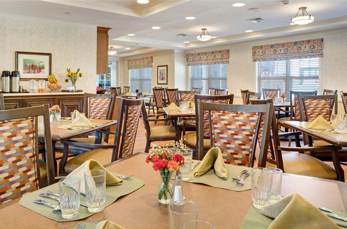 An elegant dining area with neatly set tables and comfortable seating.