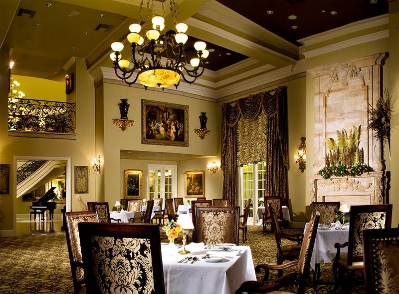 An elegant dining room with luxurious decor and a chandelier.