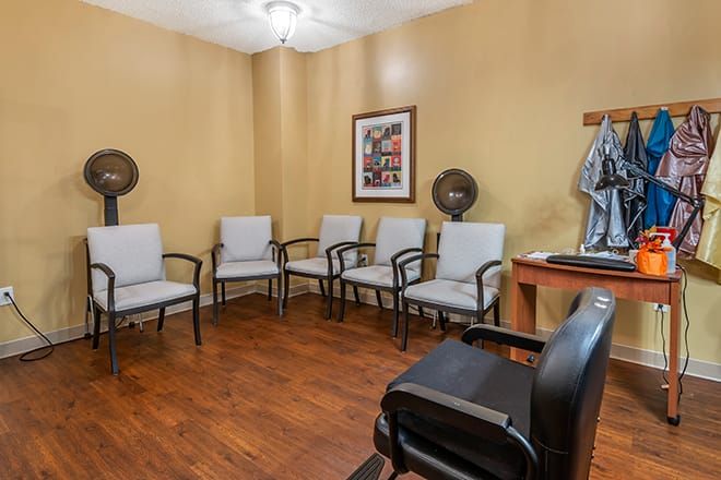 A small waiting room with several chairs and decor on the walls.