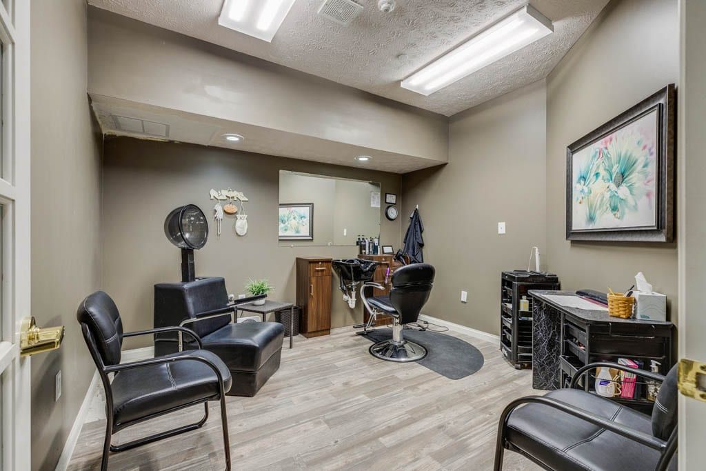 A modern hair salon interior with chairs, mirrors, and styling tools.