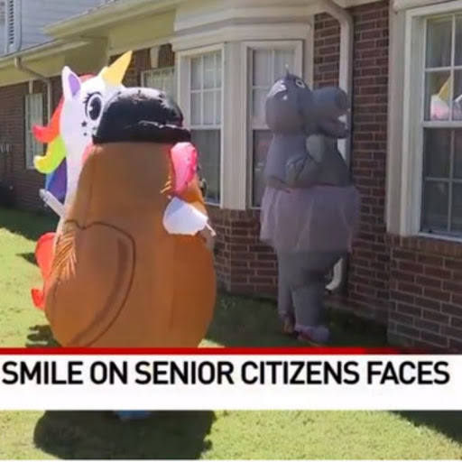 Costumed characters bring joy and laughter to senior citizens in a community event.