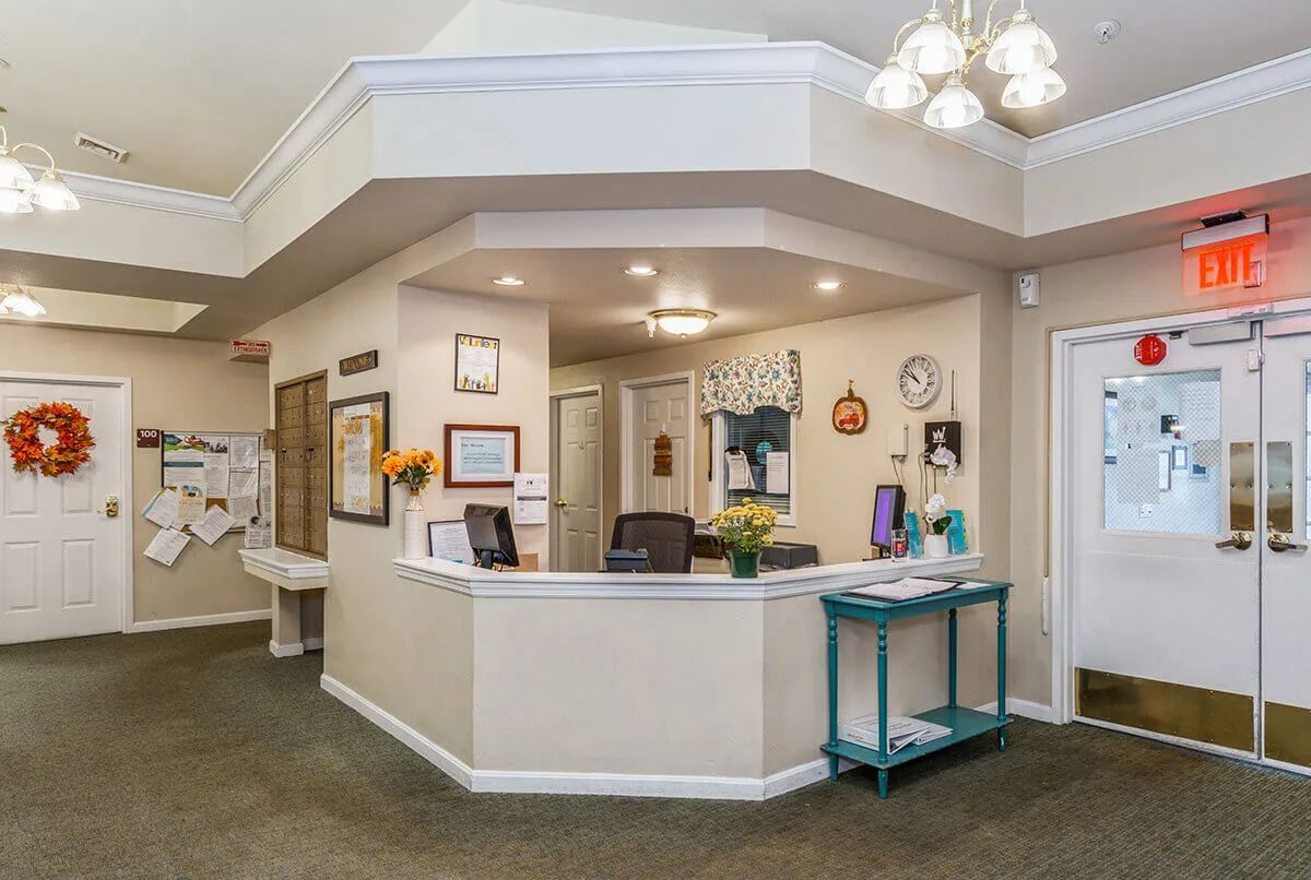 A welcoming reception area with a central desk, decorations, and seating space.