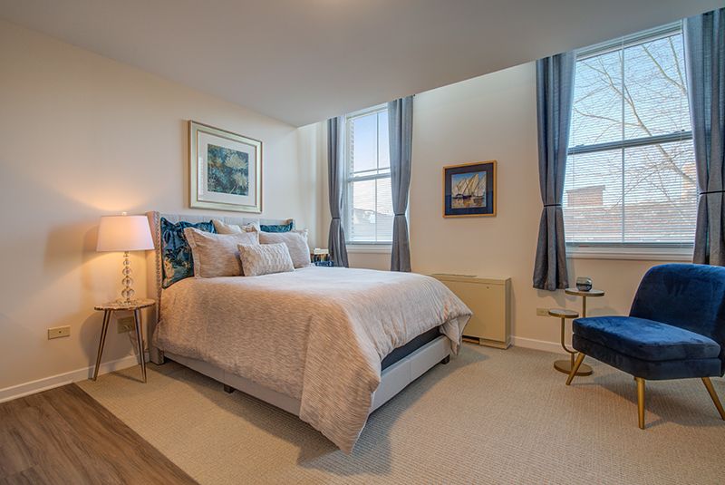 A cozy and well-decorated bedroom with elegant furnishings and artwork.