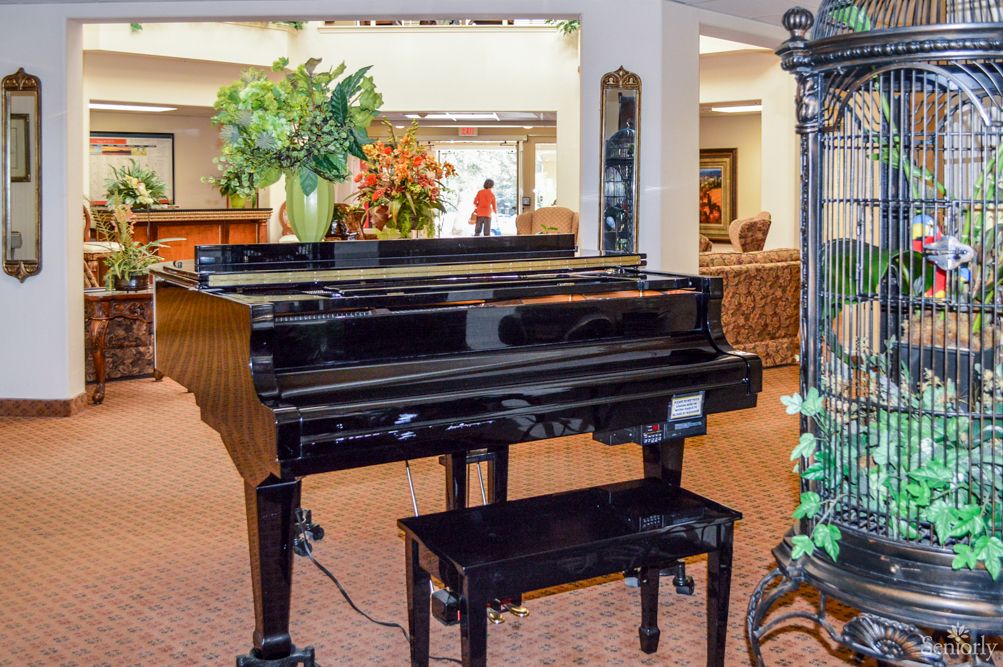 A grand piano in a warmly decorated living space.